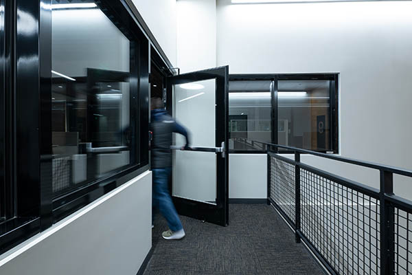 Fire-rated glass door with narrow-profile framing installed at Costco Headquarters, enhancing visibility and meeting fire safety standards.